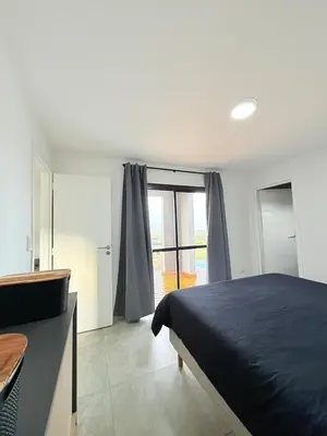 a bedroom with a bed and a large window at MontSelah Casa en la montaña con pileta para 2 in Tanti