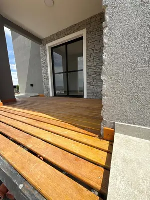 a wooden deck on the side of a house at MontSelah Casa en la montaña con pileta para 2 in Tanti