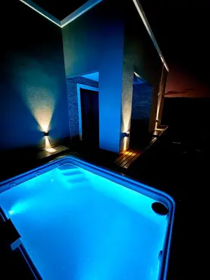 a swimming pool in a room with a blue light at MontSelah Casa en la montaña con pileta para 2 in Tanti