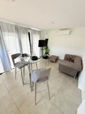 a living room with a couch and a table and chairs at MontSelah Casa en la montaña con pileta para 2 in Tanti