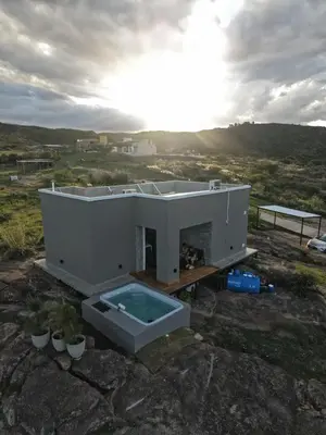 a small white house with a swimming pool at MontSelah Casa en la montaña con pileta para 2 in Tanti
