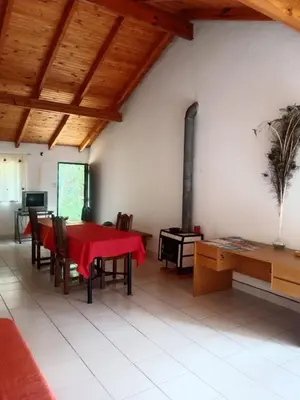 a dining room with a red table and a fireplace at Casa Los Hornillos in Los Hornillos