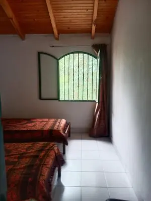 a room with two beds and a window at Casa Los Hornillos in Los Hornillos