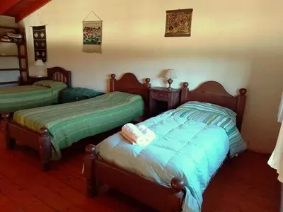 two twin beds in a room with at Los Fuegos in El Durazno