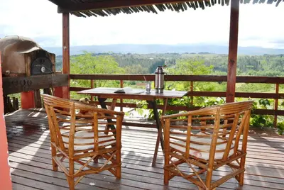 a table and two chairs on a deck with a view at Los Fuegos in El Durazno