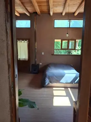 a bedroom with a bed in a room with windows at Espaz in Las Calles