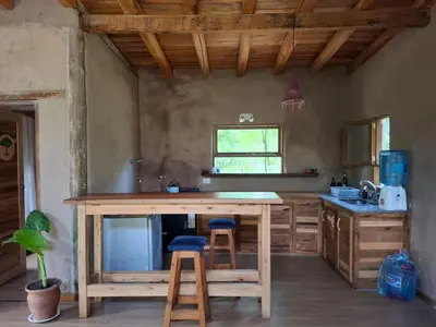 a kitchen with a large wooden island with two stools at Espaz in Las Calles