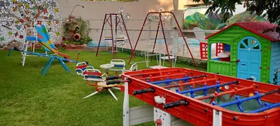 a bunch of playground equipment in a yard at Cabañas LAS AMELIAS in Villa Cura Brochero