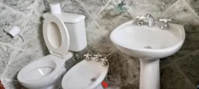 a bathroom with a toilet and a sink at Cabañas LAS AMELIAS in Villa Cura Brochero
