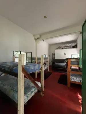 a room with several bunk beds in it at Kasananda in Villa del Dique