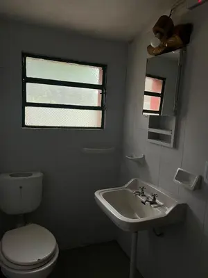 a bathroom with a white toilet and a sink at Kasananda in Villa del Dique