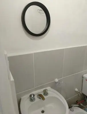 a bathroom with a sink and a mirror on the wall at Monoambiente Cerro de las Rosas in Cordoba