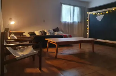 a living room with a couch and a table at Casa en Nono a 200 metros del lago in Las Rabonas