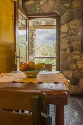 a bowl of fruit on a table with a window at Hostería Vegetariana in Country Club Chumamaya