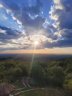 a view of the sun from the top of a hill at Hostería Vegetariana in Country Club Chumamaya