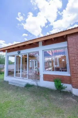a small house with a window on the side of it at Casa entera in Mina Clavero