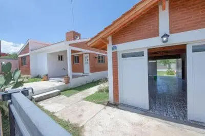 a house with a large white garage in front of it at Casa entera in Mina Clavero