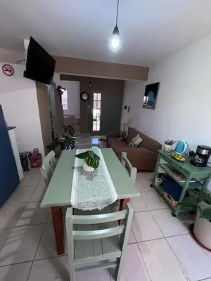 a living room with a table and a couch at Dúplex Juncal in Villa Carlos Paz