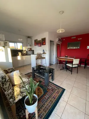 a living room with a couch and a table at El Paraiso in Villa Carlos Paz
