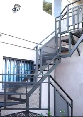 a set of metal stairs in a building at El Paraiso in Villa Carlos Paz