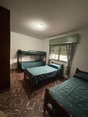 a room with three bunk beds in it at Alojamiento en Villa Cura Brochero in Villa Cura Brochero