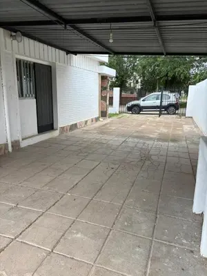 an empty parking lot with a building and a car garage at Alojamiento en Villa Cura Brochero in Villa Cura Brochero