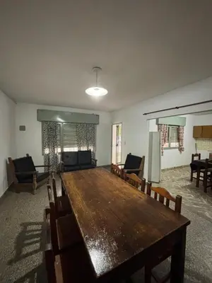 a large room with a large wooden table and chairs at Alojamiento en Villa Cura Brochero in Villa Cura Brochero