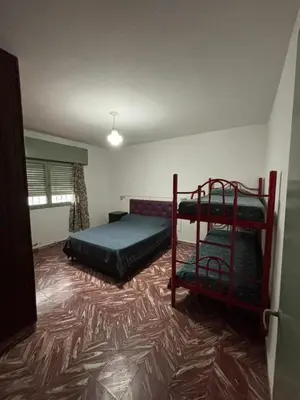 a bedroom with two bunk beds and a carpet at Alojamiento en Villa Cura Brochero in Villa Cura Brochero