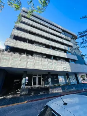 a tall building with a tree on top of it at Depto con hermosas vistas, centro con solarium y seguridad in Cordoba