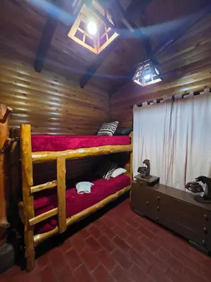 a room with two bunk beds in a cabin at Munay Ky in Villa Ciudad de America