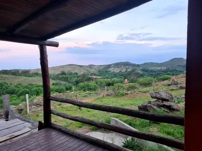 a view from the porch of a cabin with mountains in the background at Munay Ky in Villa Ciudad de America
