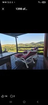 a picture of two lounge chairs on a balcony at Munay Ky in Villa Ciudad de America