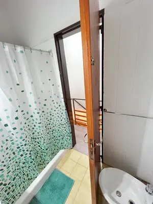 a bathroom with a shower with a toilet and a sink at Duplex Único Frente al Río in Villa Carlos Paz