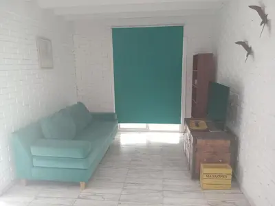 a living room with a blue couch and a tv at Virdi ca fui in Cordoba