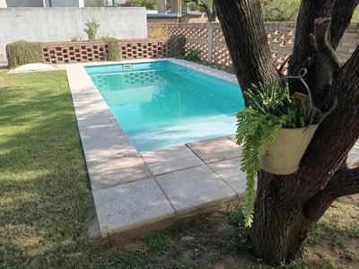 a swimming pool in a yard next to a tree at Virdi ca fui in Cordoba