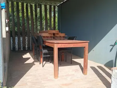 a wooden table and chairs on a patio at Virdi ca fui in Cordoba