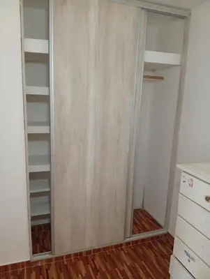 a closet with a glass door in a room at Hermosa casa a 15 min de Villa Carlos Paz in Villa Santa Cruz del Lago