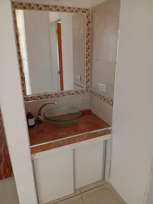a bathroom with a sink and a mirror at Hermosa casa a 15 min de Villa Carlos Paz in Villa Santa Cruz del Lago
