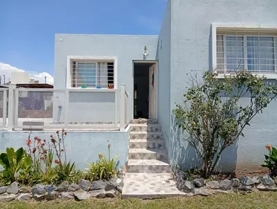 a white house with a staircase leading to the door at Hermosa casa a 15 min de Villa Carlos Paz in Villa Santa Cruz del Lago