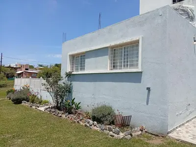 a blue house with a window on the side of it at Hermosa casa a 15 min de Villa Carlos Paz in Villa Santa Cruz del Lago