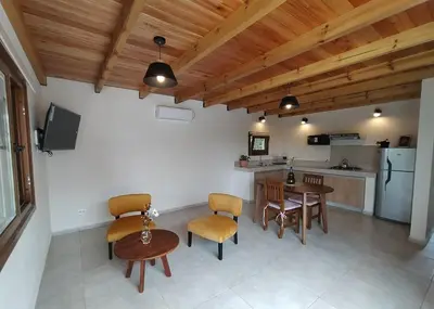 a kitchen and dining room with a table and chairs at Las Calandrias II in Los Reartes