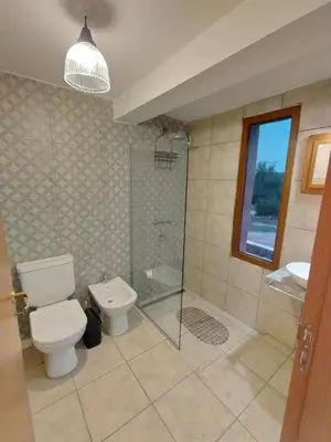 a bathroom with a toilet and a shower and a sink at Las Calandrias II in Los Reartes