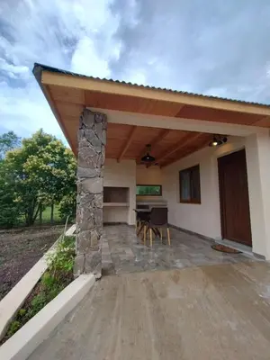a large covered patio with a table and chairs at Las Calandrias II in Los Reartes
