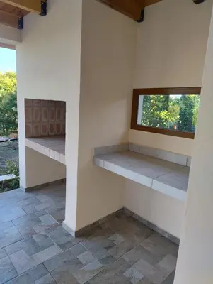 a room with two shelves and a window at Las Calandrias II in Los Reartes