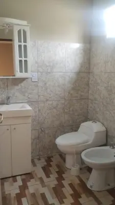a bathroom with a white toilet and a sink at Las Lomitas 2 in Villa Cura Brochero