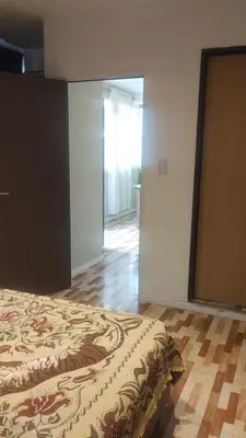 a bedroom with a bed and a door to a hallway at Las Lomitas 2 in Villa Cura Brochero