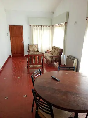 a living room with a wooden table and chairs at Casa céntrica en villa Carlos Paz in Villa Carlos Paz