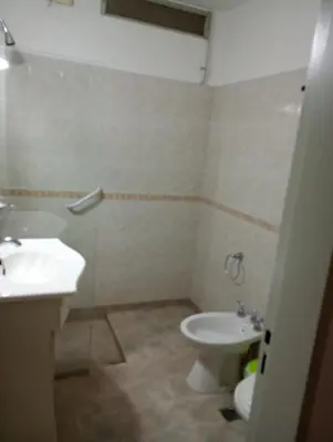 a bathroom with a toilet and a sink at Casa céntrica en villa Carlos Paz in Villa Carlos Paz