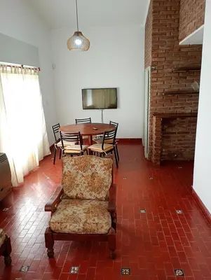 a dining room with a table and chairs and a couch at Casa céntrica en villa Carlos Paz in Villa Carlos Paz