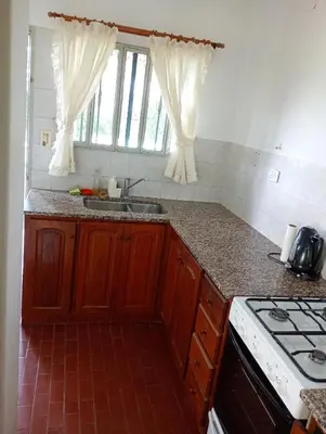 a kitchen with a sink and a stove at Casa céntrica en villa Carlos Paz in Villa Carlos Paz